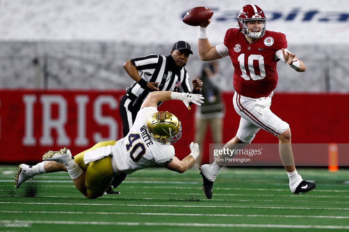 Quarterback @MacJones_10 of the #Alabama #CrimsonTide delivers a pass over linebacker Drew White of the #NotreDame #FightingIrish during the first quarter of the 2021 #CollegeFootball Playoff Semifinal Game at the #RoseBowl Game in Arlington, Texas. 📷: @penningtonphoto