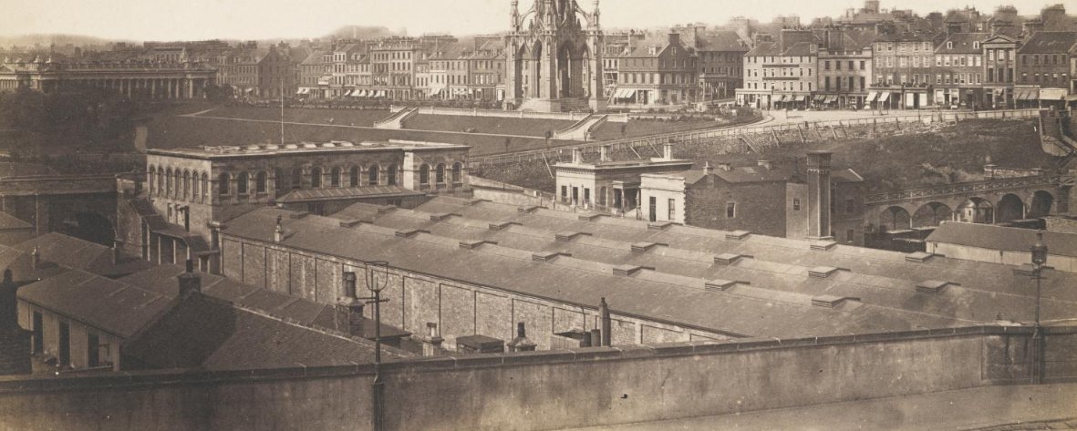 On the left is the "General" station serving the Edinburgh & Glasgow Railway, to its right is the "North Bridge" station that served the North British. These formed a through route and are on the alignment of what later became Waverley. That station hall is now the Wetherspoons