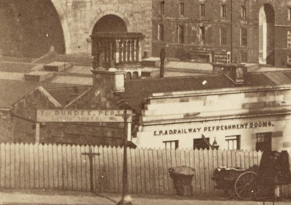 We see that squat chimney in a later photo ( https://www.nationalgalleries.org/art-and-artists/120403/old-town-seen-princes-street-waverley-bridge-carriages-and-horses-foreground-edinburgh-scotland?search=waverley&search_set_offset=4) taken from Princes Street, by which time the railway was part of the Edinburgh, Perth & Dundee. The Edinburgh side was an island, connected to the main network across the water by the Granton train ferries.