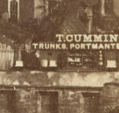 One of the things about these old photos is just how crisp the detail is - we can easily see what sort of shops and businesses were around, helped out by all those over-sized signs that proprietors used to paint on their premises.T. CUMMINS.TRUNKS, PORTMANTEAUX...