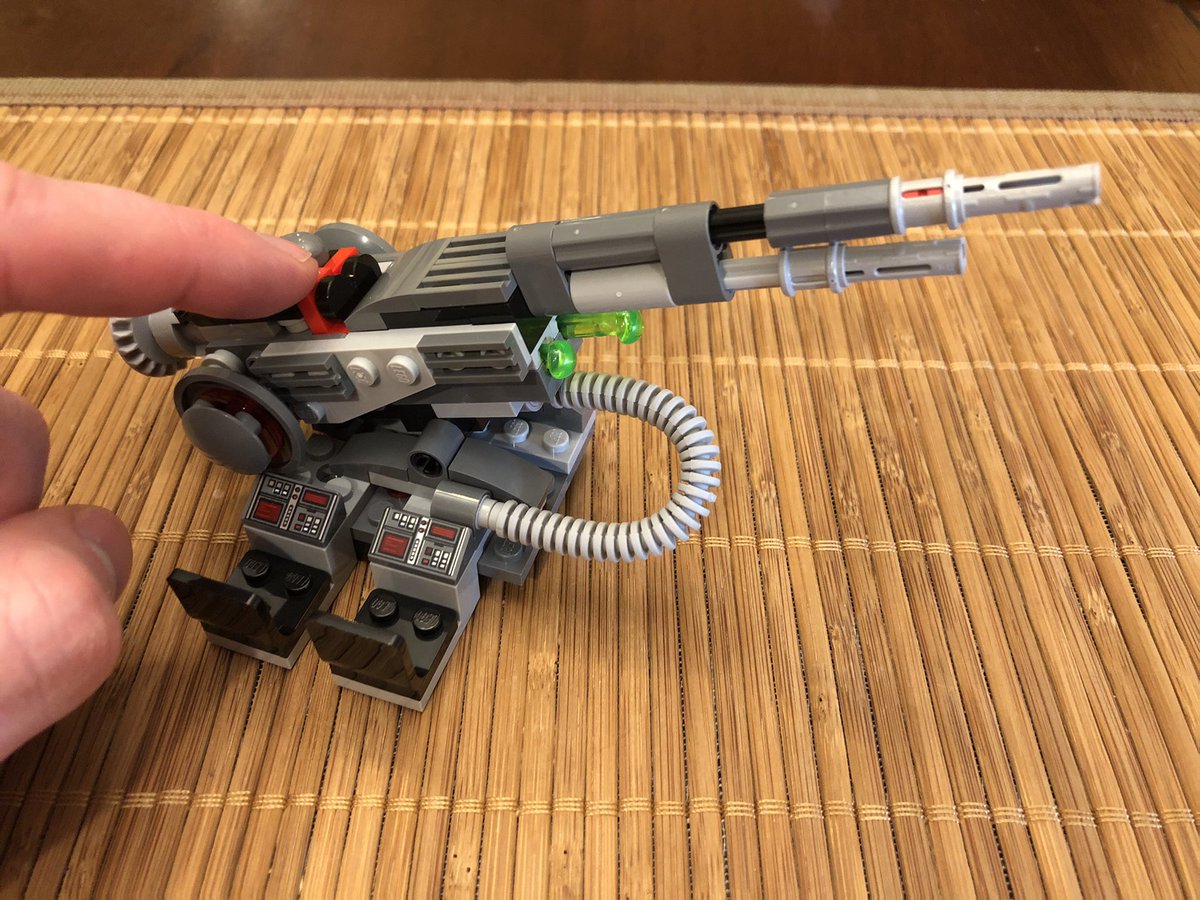 The cannon has two shots, fired by the red/black buttons here. There are two extra shots that attach to the wall. Slap the cannon down on the rotating piece and put the two techs in the seats!  #LEGO  