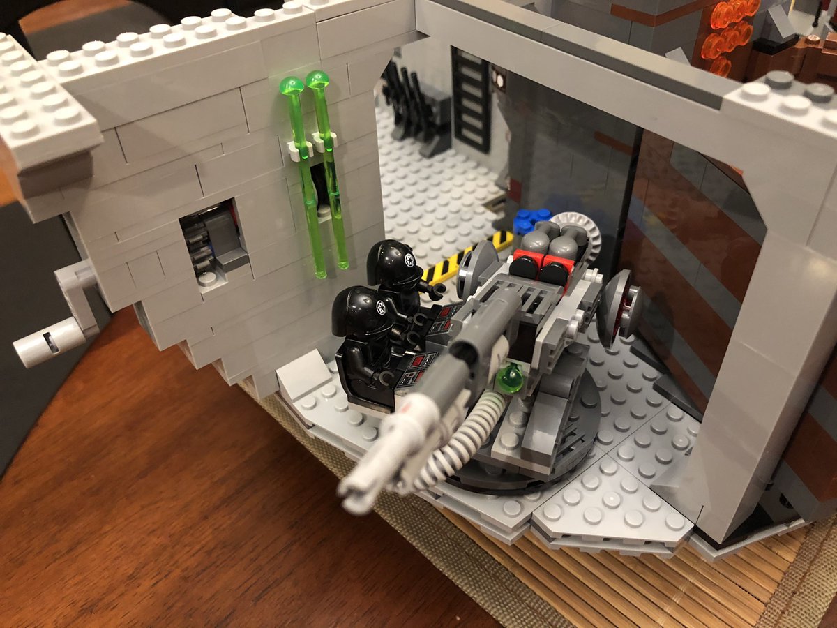 The cannon has two shots, fired by the red/black buttons here. There are two extra shots that attach to the wall. Slap the cannon down on the rotating piece and put the two techs in the seats!  #LEGO  