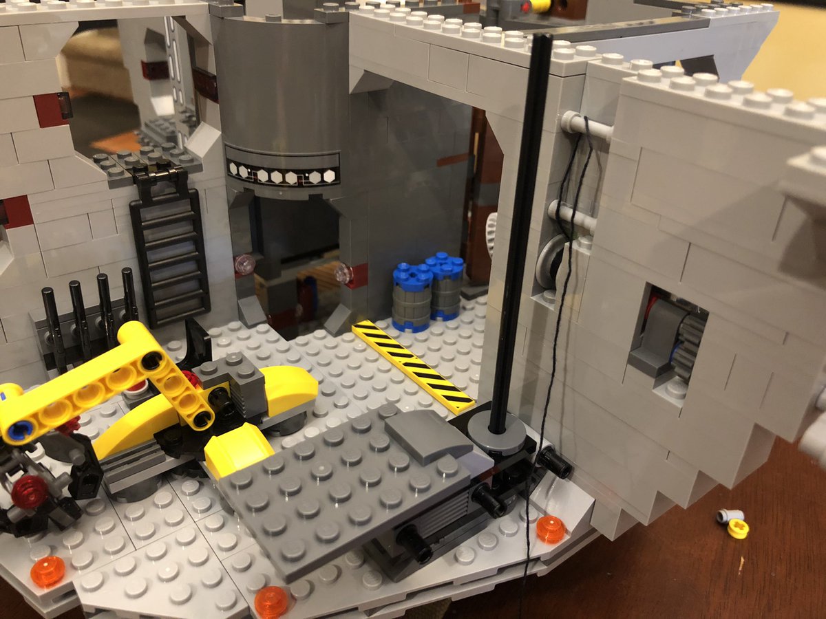 Slap it on the rod in the cargo bay. This final assembly goes on top to pin it in place. Be sure to thread the string around the poles and up and down through the top piece, then...  #LEGO  