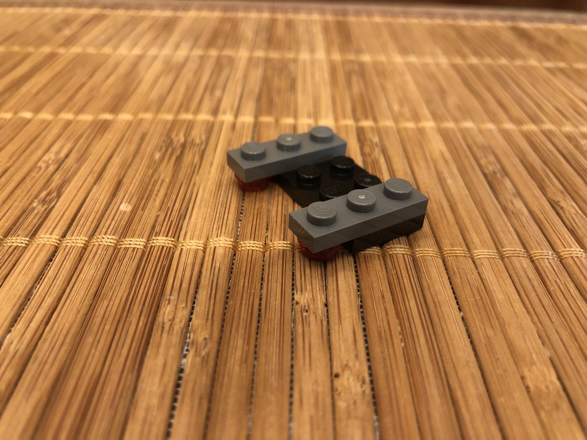 Slap it on the rod in the cargo bay. This final assembly goes on top to pin it in place. Be sure to thread the string around the poles and up and down through the top piece, then...  #LEGO  