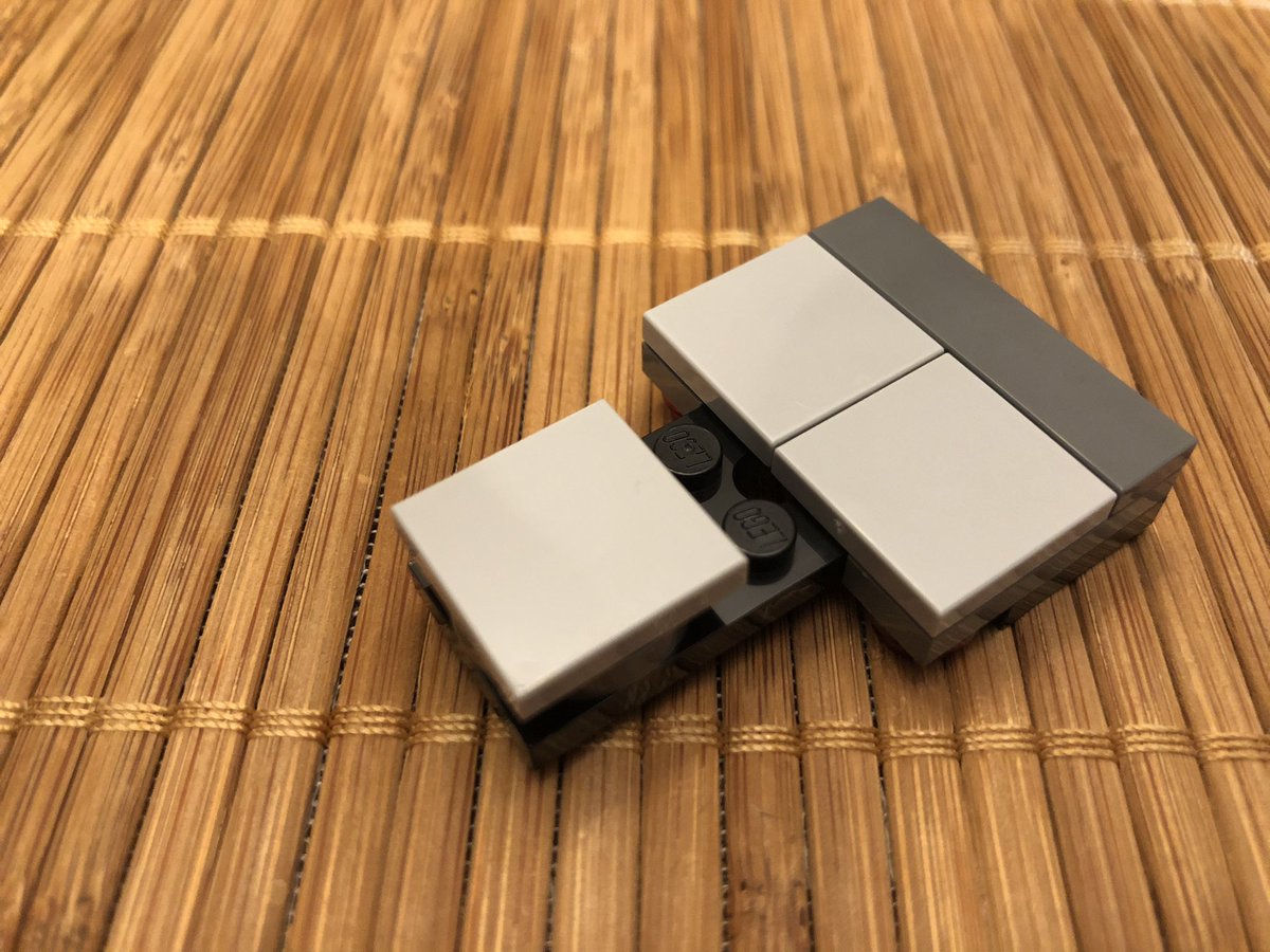 Slap it on the rod in the cargo bay. This final assembly goes on top to pin it in place. Be sure to thread the string around the poles and up and down through the top piece, then...  #LEGO  