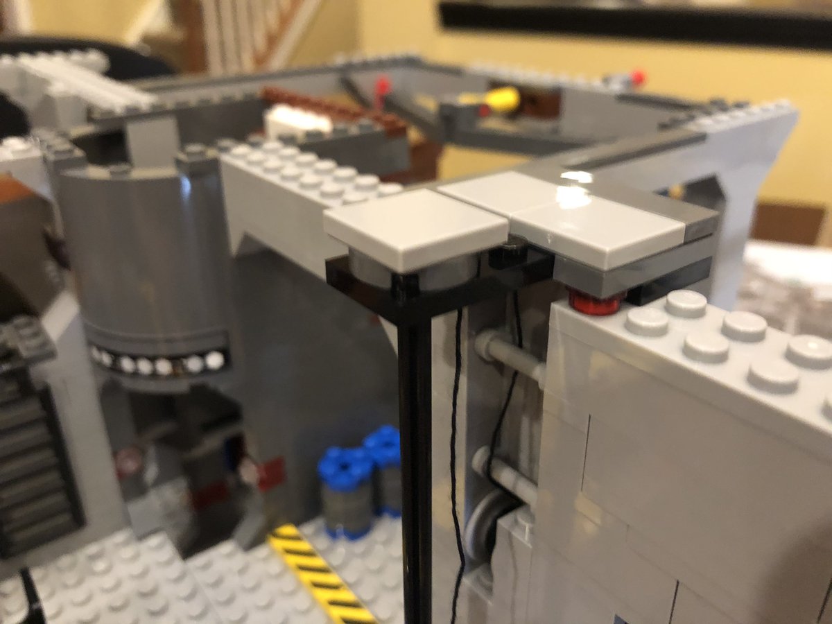 Slap it on the rod in the cargo bay. This final assembly goes on top to pin it in place. Be sure to thread the string around the poles and up and down through the top piece, then...  #LEGO  