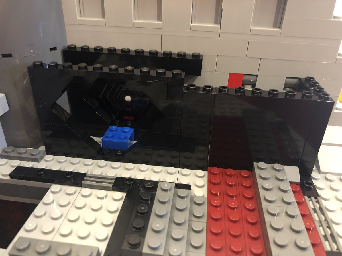 Some more half tanks, with the upper and left ones having this decal on them, and some glass above the consoles finishes off the walls. Turn the Death Star 90deg clockwise and place these gates in that room.  #LEGO  