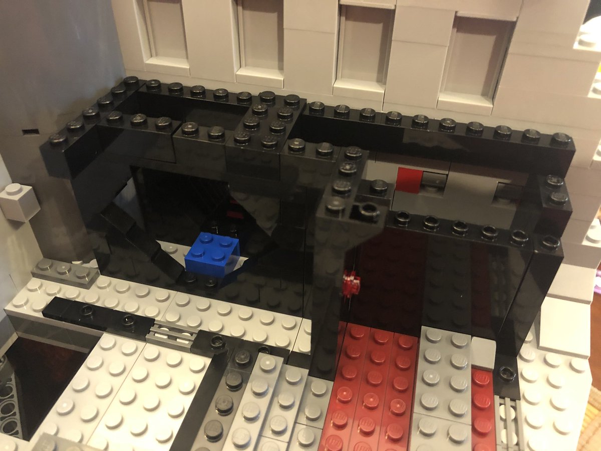 Some more walls go around the gates we just placed, and some sloped pieces around the hole in the floor. It gets covered with a grate that can rotate. Figure it out?  #LEGO  