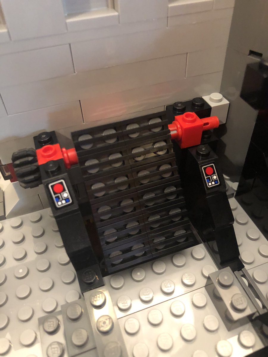 Some more walls go around the gates we just placed, and some sloped pieces around the hole in the floor. It gets covered with a grate that can rotate. Figure it out?  #LEGO  