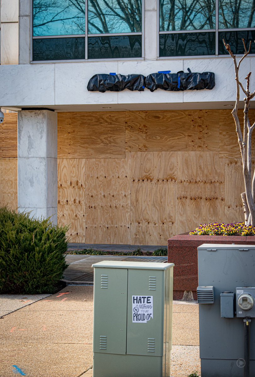 Nearly every business near the fences was boarded over, protecting glass from whatever the owners were afraid of.This business even wrapped up the sign to make it unidentifiable.A sign was posted; “HATE IS NOTHING TO BE PROUD OF”. #DCLockdown  #BenjaPhoto