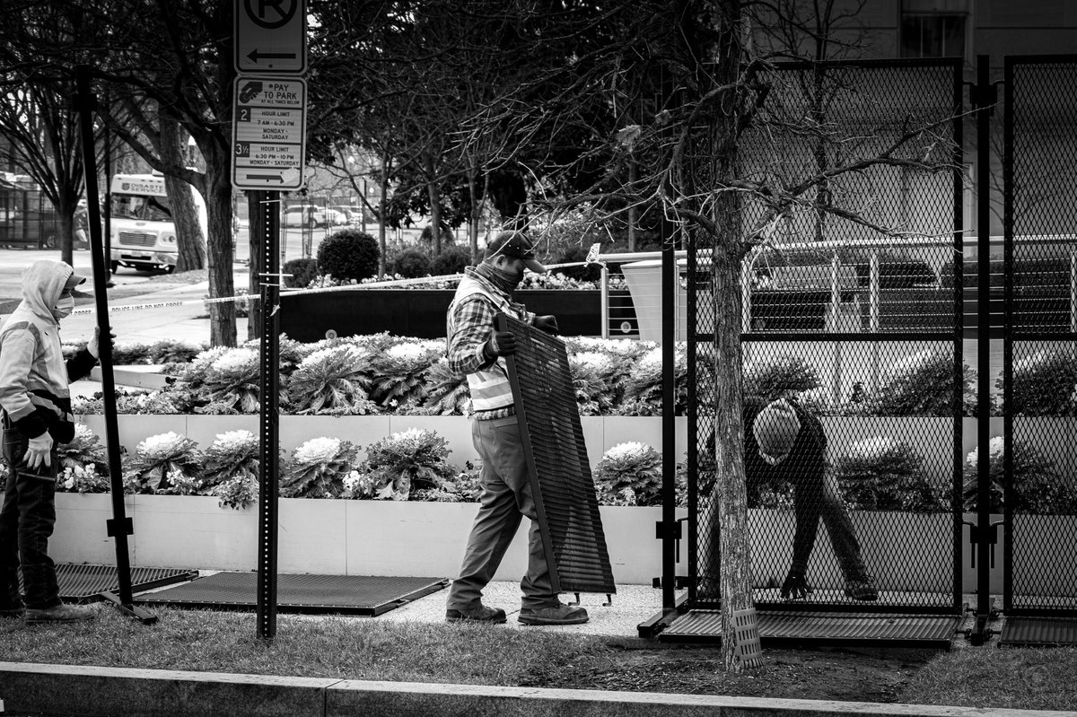 As we walked, the boundaries kept advancing on us. Trucks of freshly fabricated fencing rumbled in and were rapidly unloaded by forklifts. Teams of Spanish speaking men slammed them together, securing blocks in less than half an hour. #DCLockdown  #BenjaPhoto