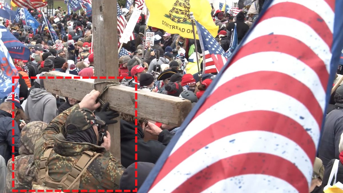 Person on Radio in Military Gear hiding behind wooden cross  @FBIWFO