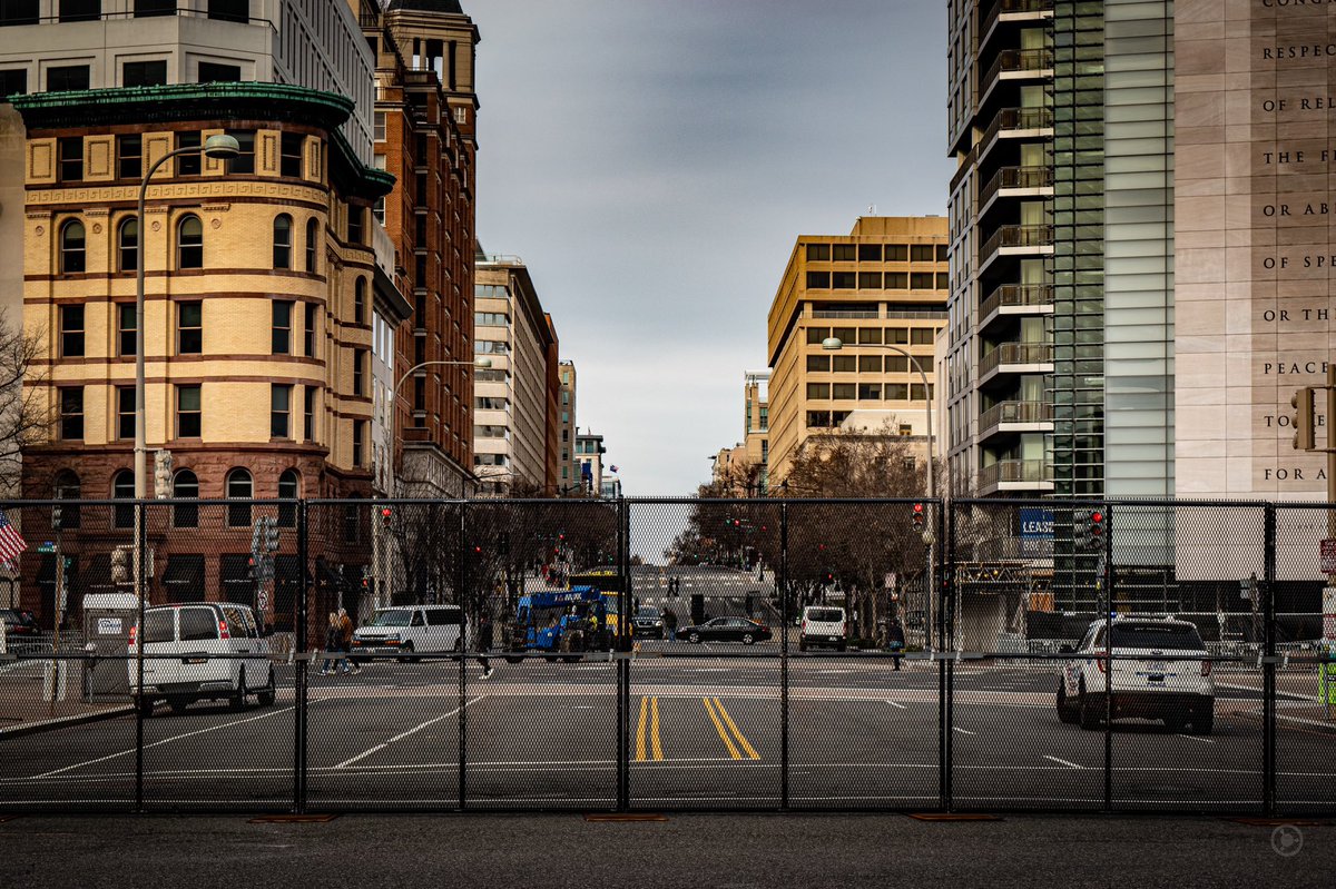 Some fencing zigzagged across streets with no apparent direction, other than just to be a show of force. DC streets bisect at angles and wedges, and some of the fencing stood in odd places that could easily be walked around. #DCLockdown  #BenjaPhoto