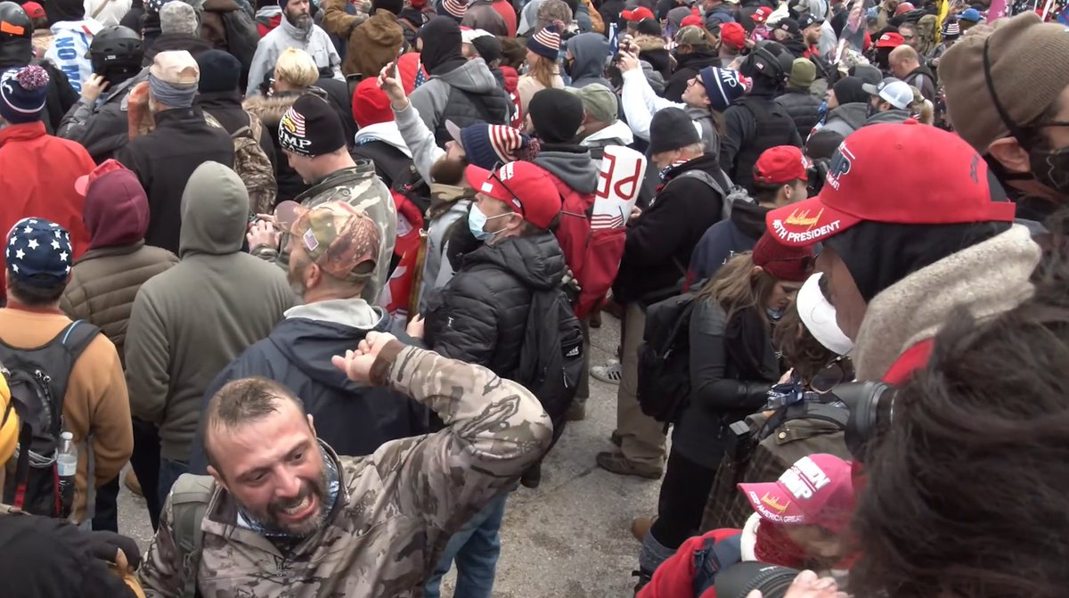 "If you ain't ready to go in there, get the f**k out of here." yells a rioter in tan camouflage