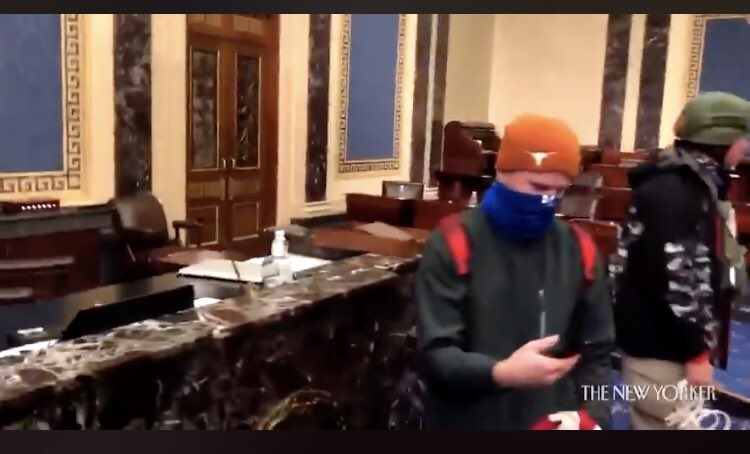 evanasmith's tweet photo. Who’s wearing the Texas Longhorn ski cap in this inside-the-insurrection video from @newyorker? https://t.co/8NJx6kNVb4 https://t.co/uBxLcCbkdO