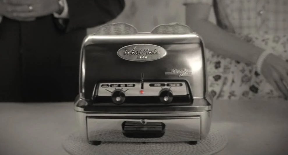 Episode 1’s commercial shows us how much Wanda’s psyche is influencing this reality. Some of the only color used is the red from the toaster. The toaster beeps constantly sort of like a bomb ticking away...it’s also a Stark Industries product like the bomb that killed her parents