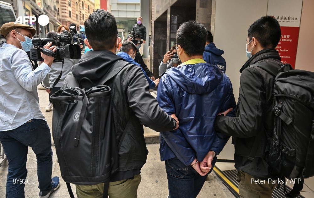 AFP's tweet photo. #UPDATES China's crackdown in Hong Kong escalates dramatically with police arresting as many as 50 opposition figures, most on a charge of “subversion,”  in their largest operation since a draconian security law was imposed https://t.co/twUsQ5ndVM https://t.co/ZWCwBUs9og