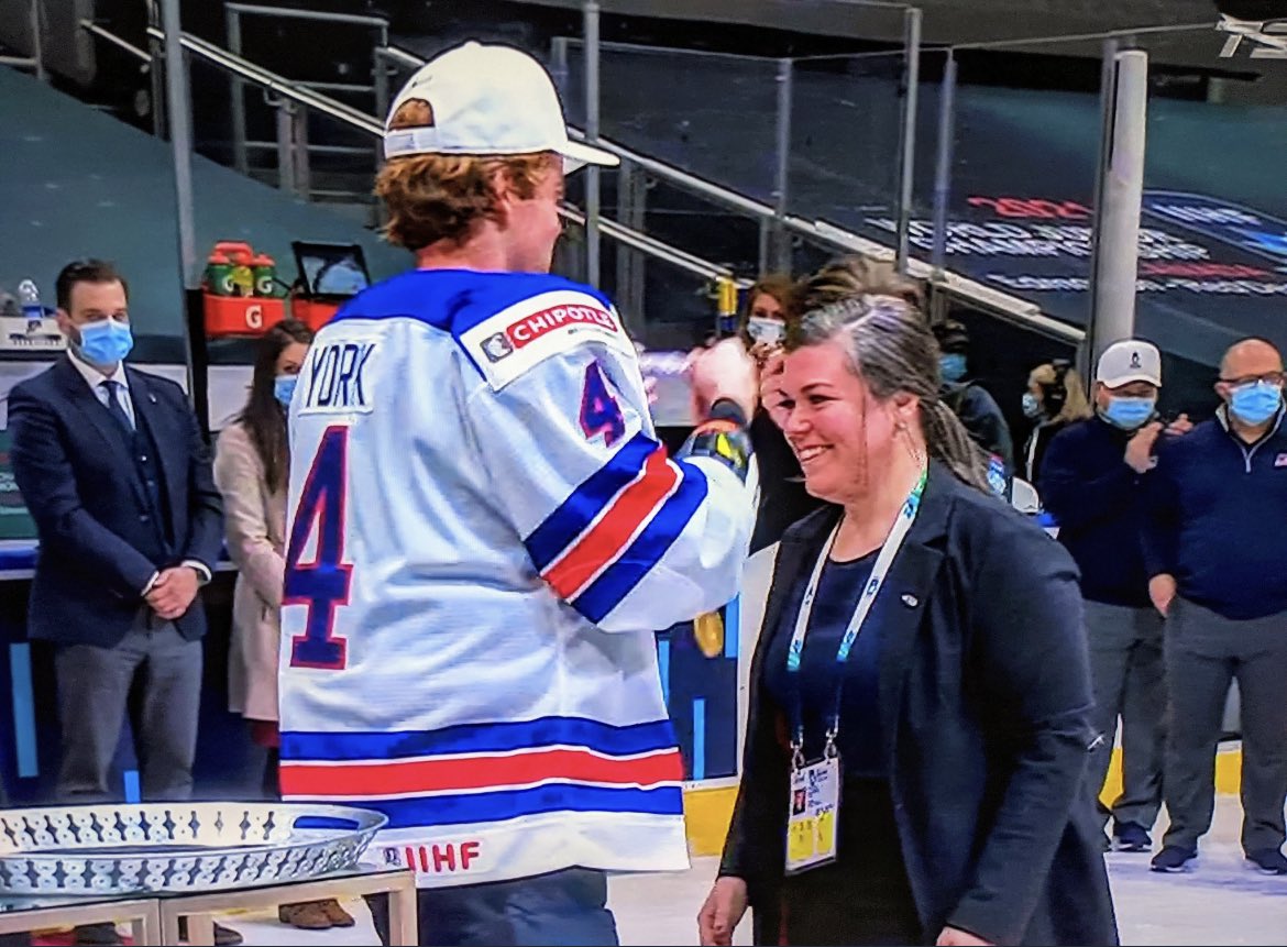 PHF's tweet image. Historic moment at the #WorldJuniors Congratulations, Theresa Feaster on being the first female assistant coach at the Men’s World Juniors and the first female assistant coach to bring home the gold there. 100% of the time it works every time to have females behind the bench!