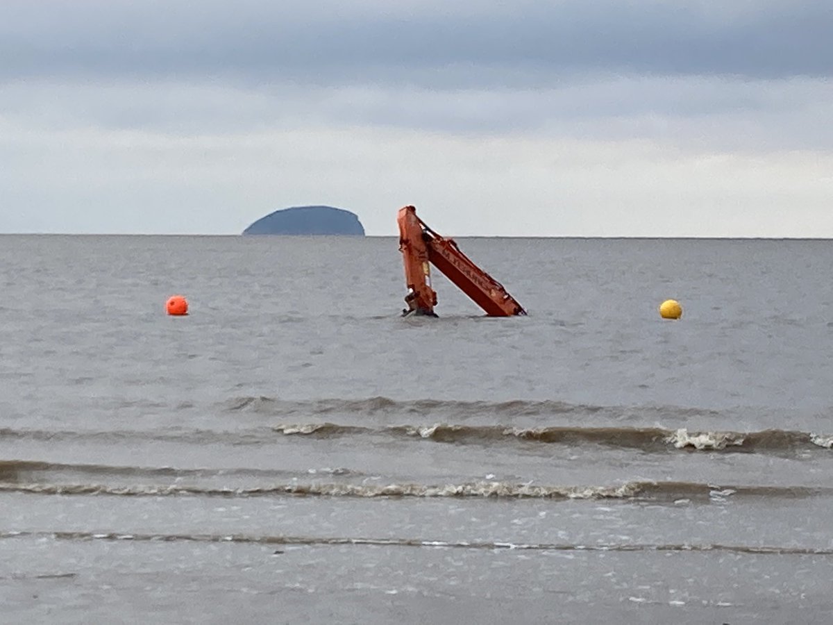 An excavator that got stuck on Weston-super-Mare beach. It was trying to free a dump truck that itself became stuck whilst dispersing sand from a sand sculpture exhibition
