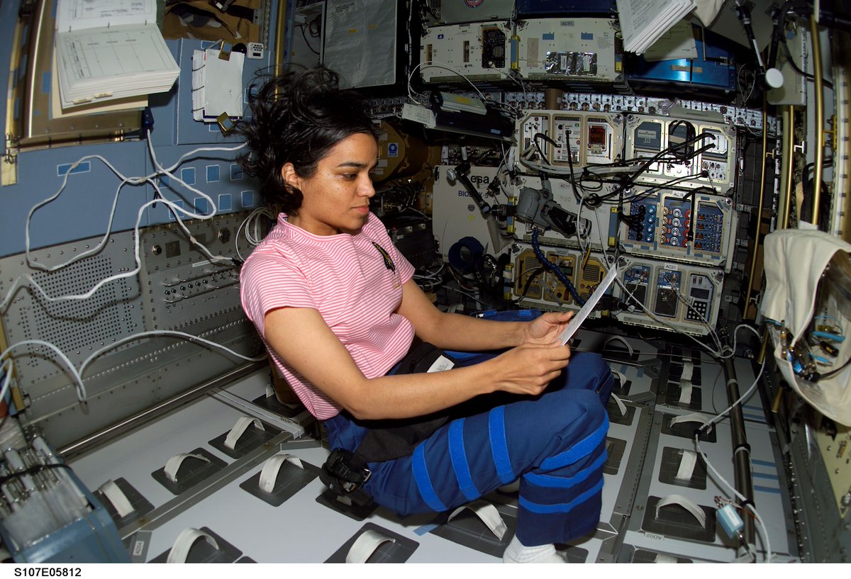 Astronaut Kalpana Chawla, STS-107 mission specialist, looks over a procedures checklist in the SPACEHAB Research Double Module aboard the Space Shuttle Columbia in 2003.
