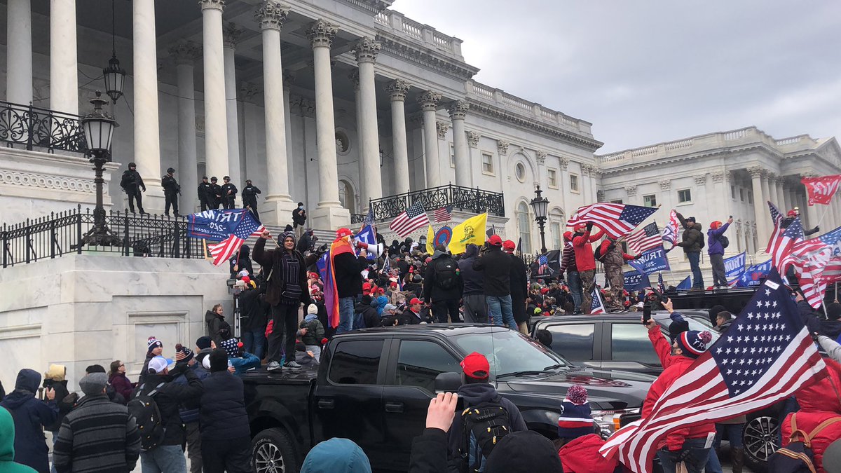 They did it. Trump supporters broke the police line and have rushed to the top of the steps. They’re shouting “USA!” and “four more years!” One man is shouting Q conspiracies into a megaphone. The police set off one stun grenade at first, but now seem to be letting them be.  #DC
