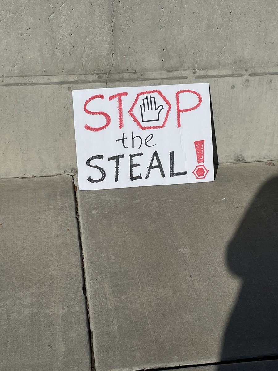 Some signs resting on the ground outside the Capitol: