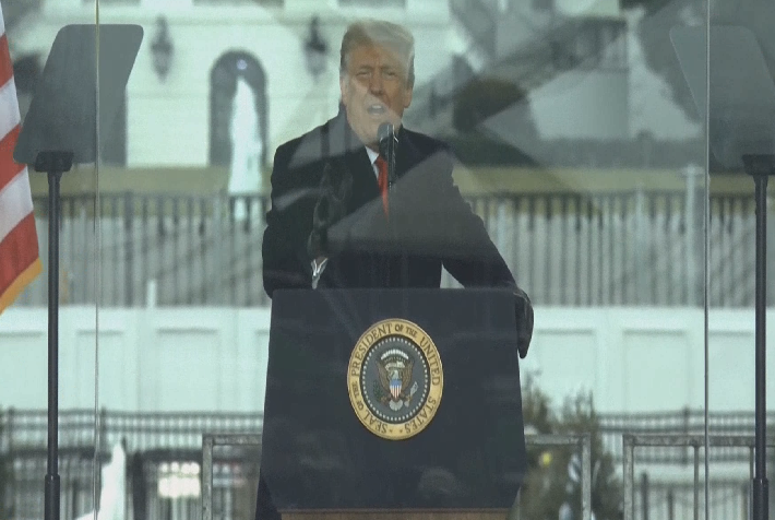 josh_wingrove's tweet photo. Trump just told the crowd he will join them in marching over to the Capitol. 

(It's not clear whether he actually will, given he drove from the building behind him in a motorcade and is speaking from behind bulletproof glass.) https://t.co/42TorKovlR