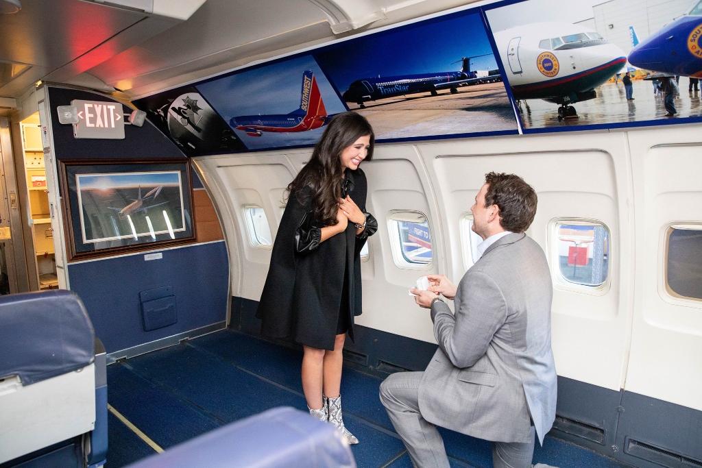 Their first date was a week later, when Michael drove 6 hours to see Cathlyn. After a year, Michael popped the question inside the cabin of the first ever Southwest plane at the Frontiers of Flight Museum in Dallas, recreating the moment they had first met. (3/7)