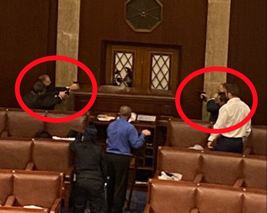 There is now an armed standoff at the door of the House. Cops have their guns drawn and barricaded the door.