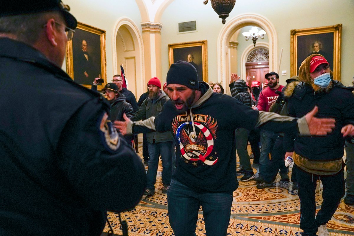 Protesters stand before U.S. Capitol Police outside the Senate chamber after storming the Capitol.⁠ Manuel Balce Ceneta / AP