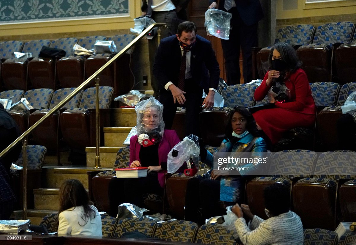 GettyImagesNews's tweet photo. People in the House Chamber wear escape hoods after protesters breached the #USCapitol during a joint session of #Congress in #WashingtonDC 📷:  @drewangerer #CapitolBuilding https://t.co/o6Gq4qQlVu
