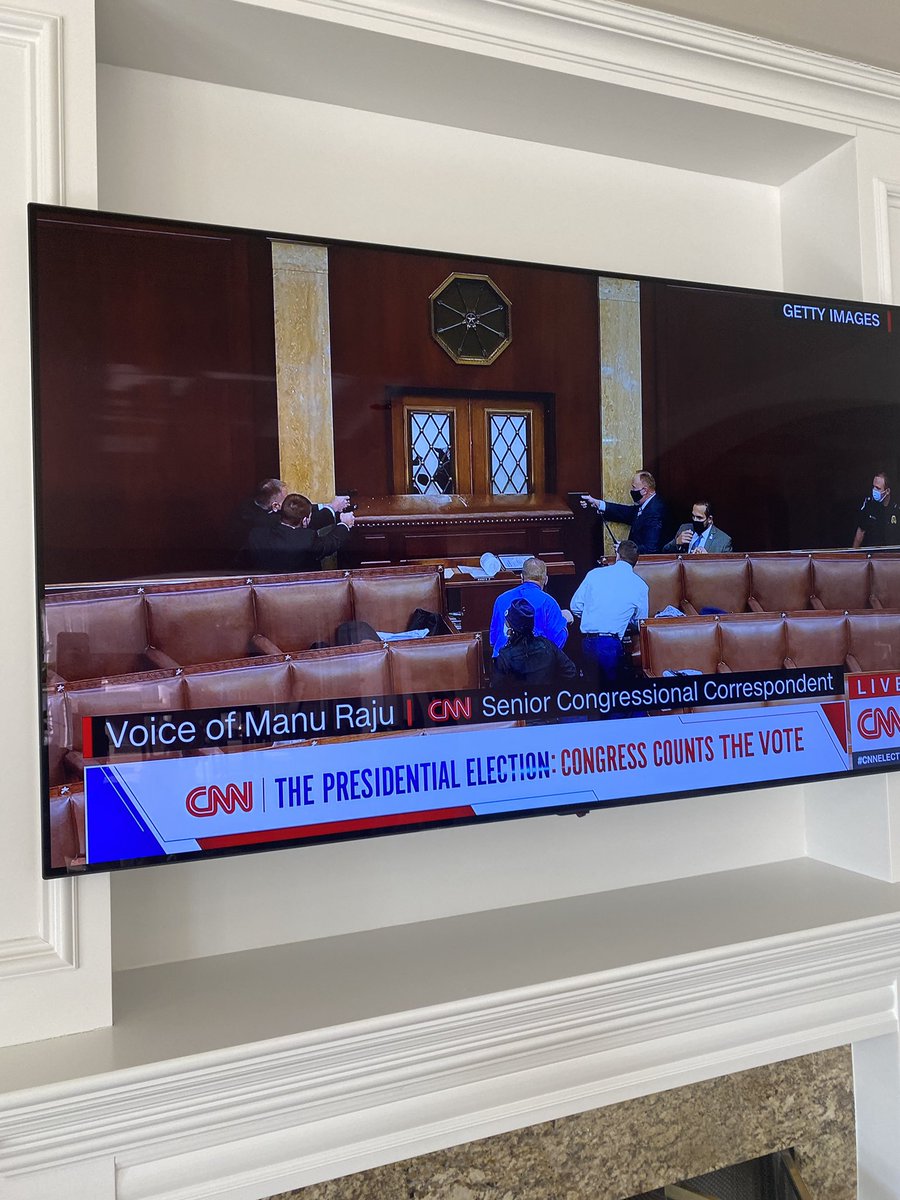1/3 Trump supporters break the doors down of the Capitol building and one of the armed men is trying to break into the Senate. Police have used a desk to block him from entering, guns raised while he breaks the glass. They are giving him TIME to stand down.