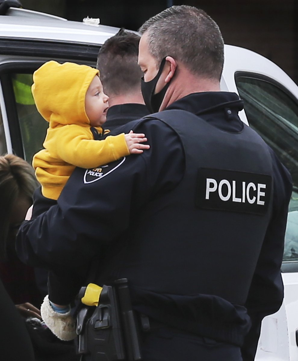 Dan_Janisse's tweet image. I'm going to ignore Covid-19 and the burning dumpster fire in the U.S. for a brief moment and share a sweet pic of @WindsorPolice Colin Wemyss holding a toddler today at the scene of a minor traffic accident. The baby's mother was being checked out by medics. Everyone was fine.