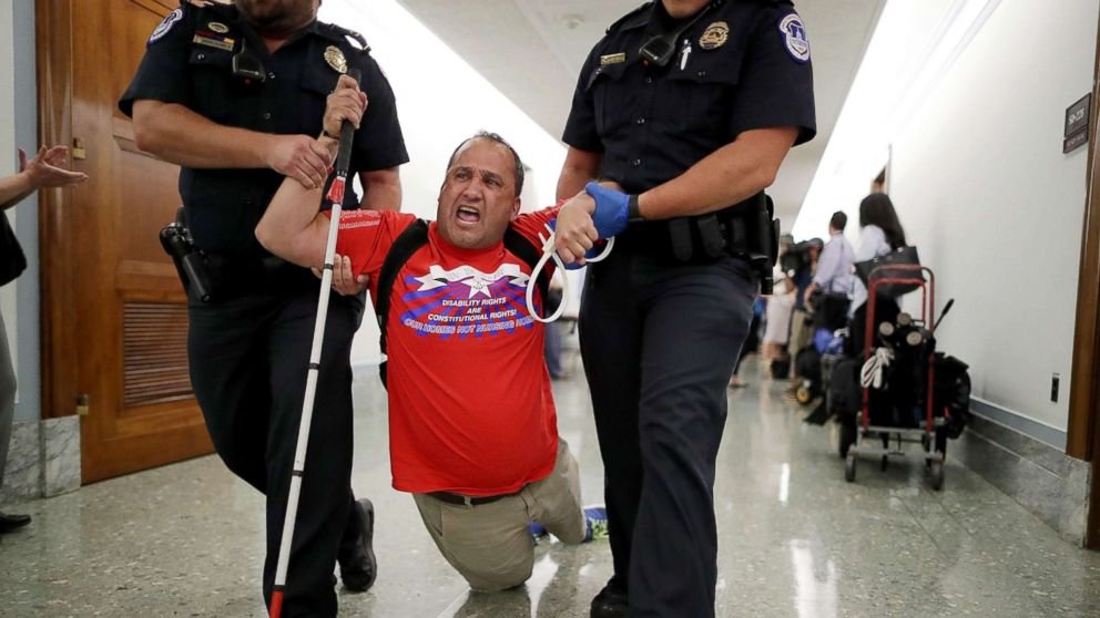 When legislators considered brutal cuts to Medicaid for disabled people,  @CapitolPolice ziptied & dragged out peaceful protesters with physical disabilities. Today Capitol Police walked looters around & took selfies with them.