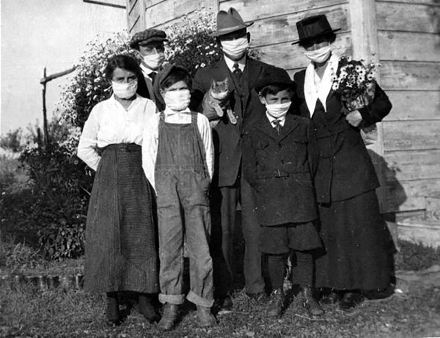 Portraits of families (and their pets) wearing masks during the Spanish flu pandemic. Photographed in 1918.
