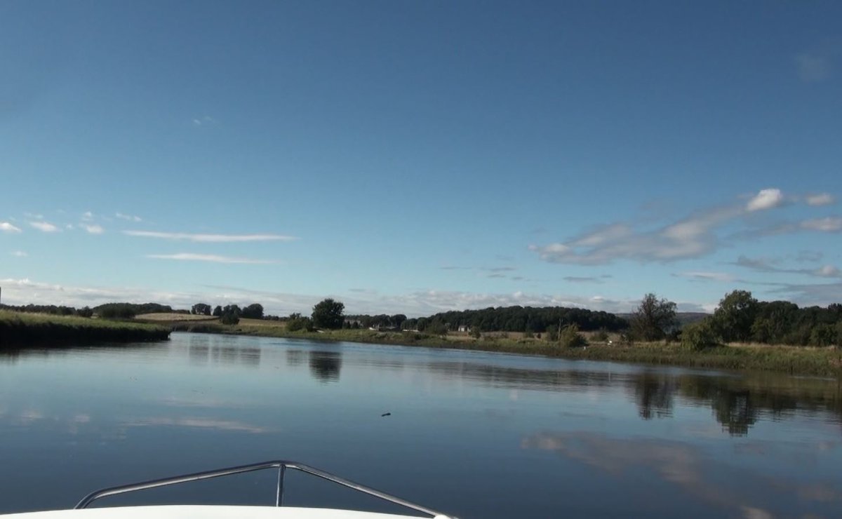 23.The old bridge behind, and passing the remains of St Hallows Church on my right (historical interest, very haunted) with Glasgow airport runway on my left, the river became suddenly very serene, the countryside opening out on each side of me, the sky big, warm, and welcoming