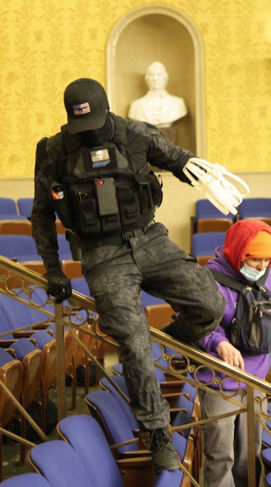 tariqnasheed's tweet photo. Here is an image of one of the white supremacists from the attempted coup at the Capitol building, wearing a side arm, and carrying zip ties.

The only reason to storm a federal building with a gun and zip ties is if you planned on taking HOSTAGES at gunpoint. https://t.co/XzT0NoGzvr