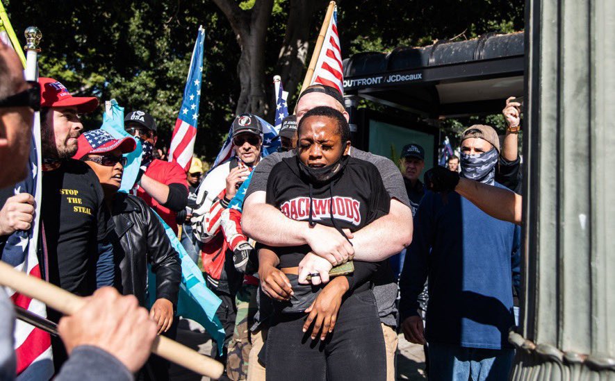 tariqnasheed's tweet photo. A Black woman passing by on her way home was surrounded by a mob of suspected white supremacists who harassed her, beat her, and maced her. 

Not only were no arrests made, one of the suspected white supremacists did a tv interview afterwards https://t.co/4EOy8pgzLo