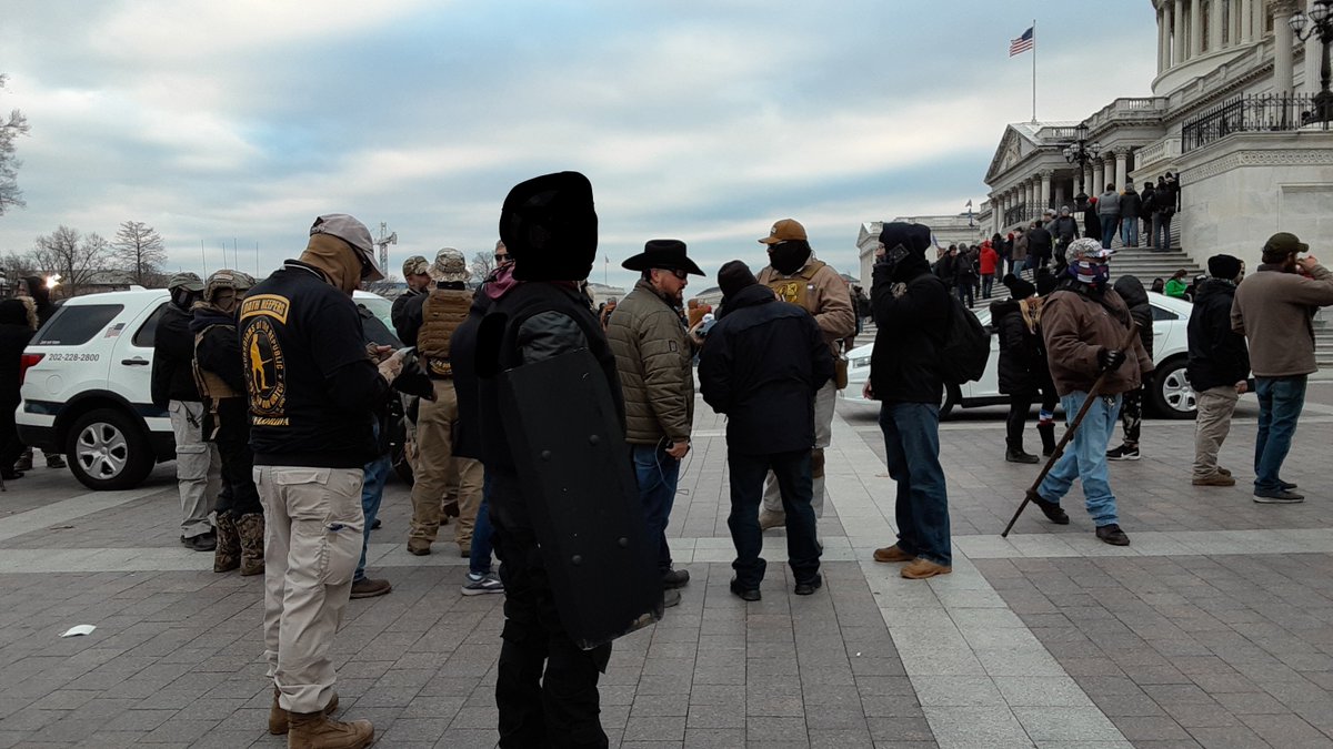 Far-right militia group the Oathkeepers were present yesterday. Here's about a dozen of them talking outside the Capitol.[blacked out face of one person who was probably a Trumper, but based on clothing I was not certain.] 4/