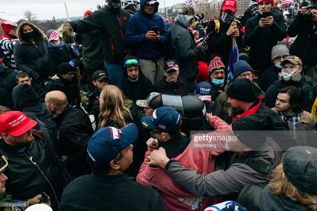 Demonstrators physically remove a Metropolitan Police officer after capturing him and locking him in a handicap elevator at the U.S. Capitol building during a protest in Washington, D.C., U.S., on Wednesday, Jan. 6, 2021.