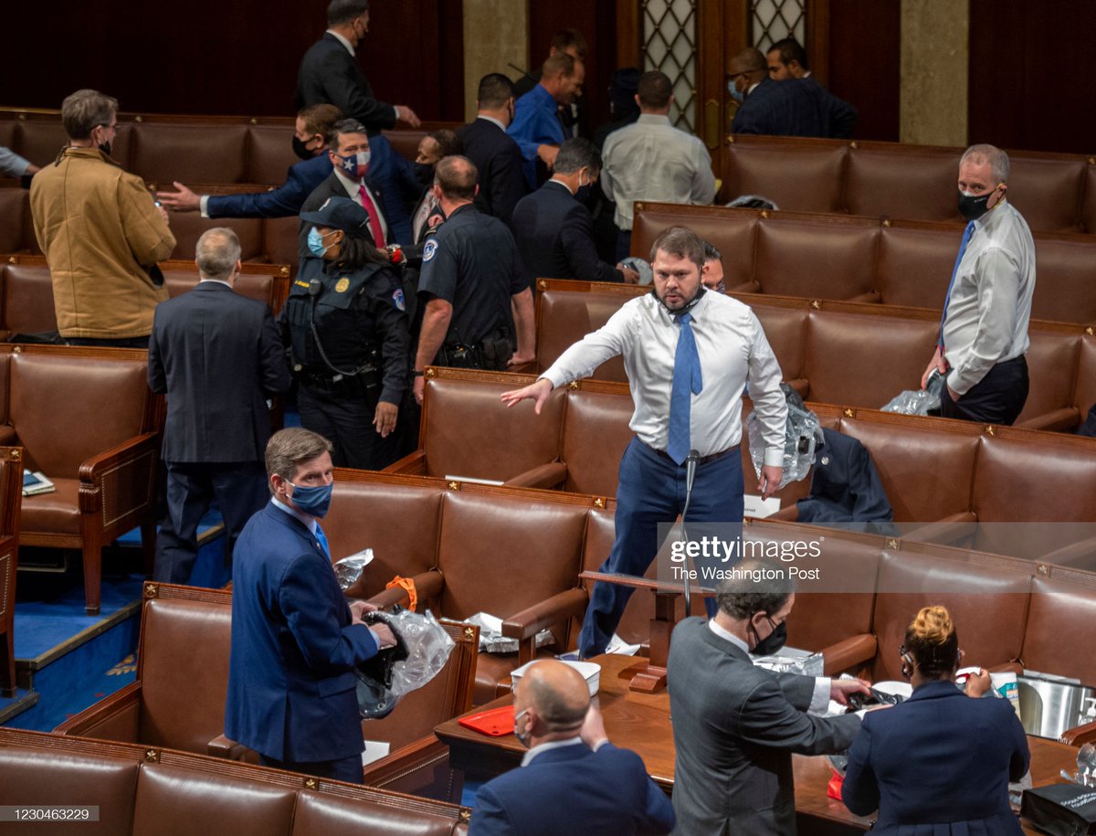 Staffers and members wrestle with safety hoods from under the desks as protestors breach the Capitol building during the 117th Congress holds a joint session to certify the Presidential election results, in Washington, DC on January 06.
