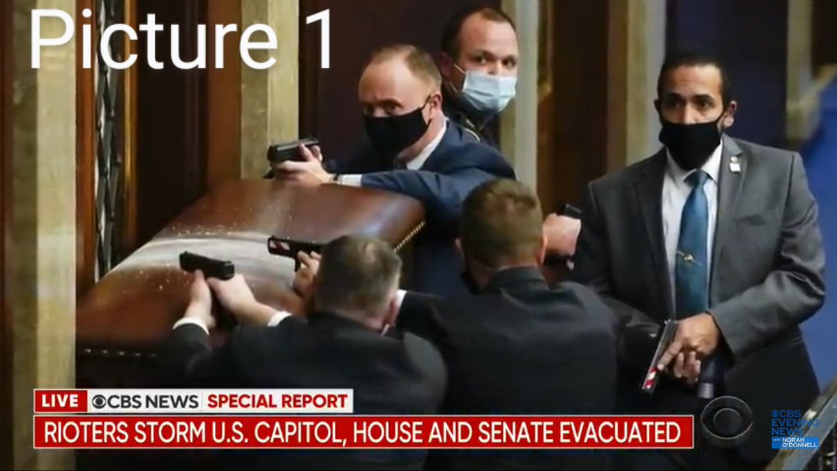 PICTURE :Why is the lady in Red dress, happily pose to the camera,holding the gas mask in hand?PICTURE : Why is this cop posing at the camera, instead of pointing his gun to the Antifa,who is lying down with his hands so close to his feet and could easily pull him down?