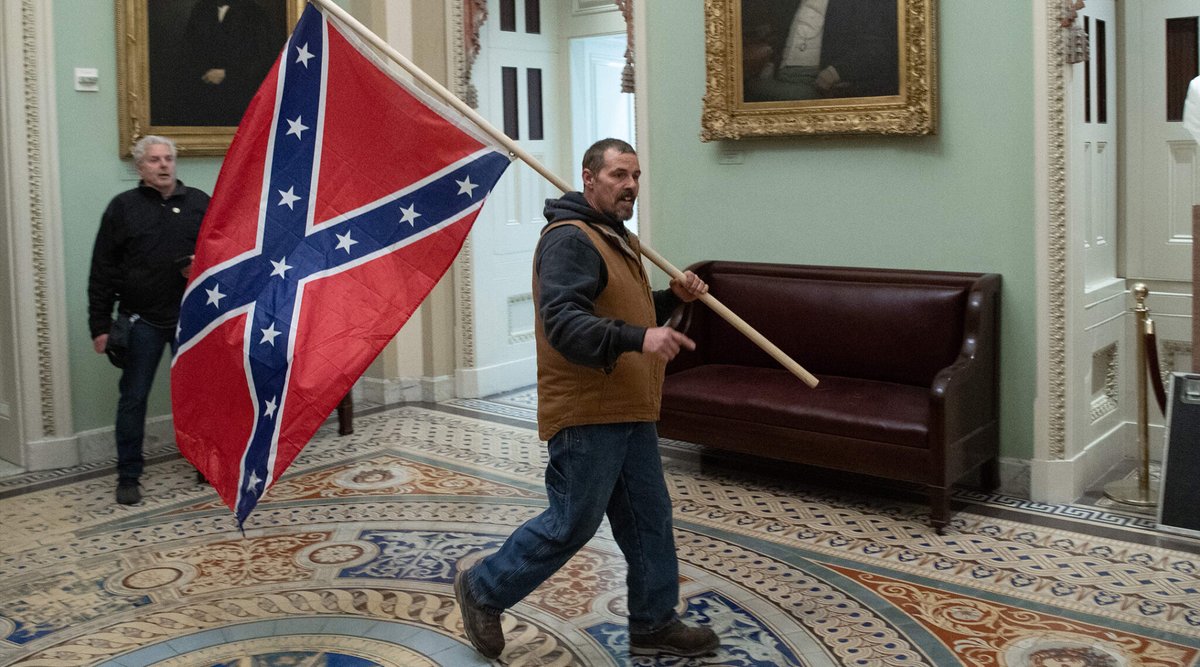 KenRoth's tweet photo. The liaison between white supremacy and anti-Semitism: a Confederate flag in the Capitol, a "Six Million Weren't Enough" shirt in the streets. https://t.co/foO3gdrGsv https://t.co/LSJT8U9mon