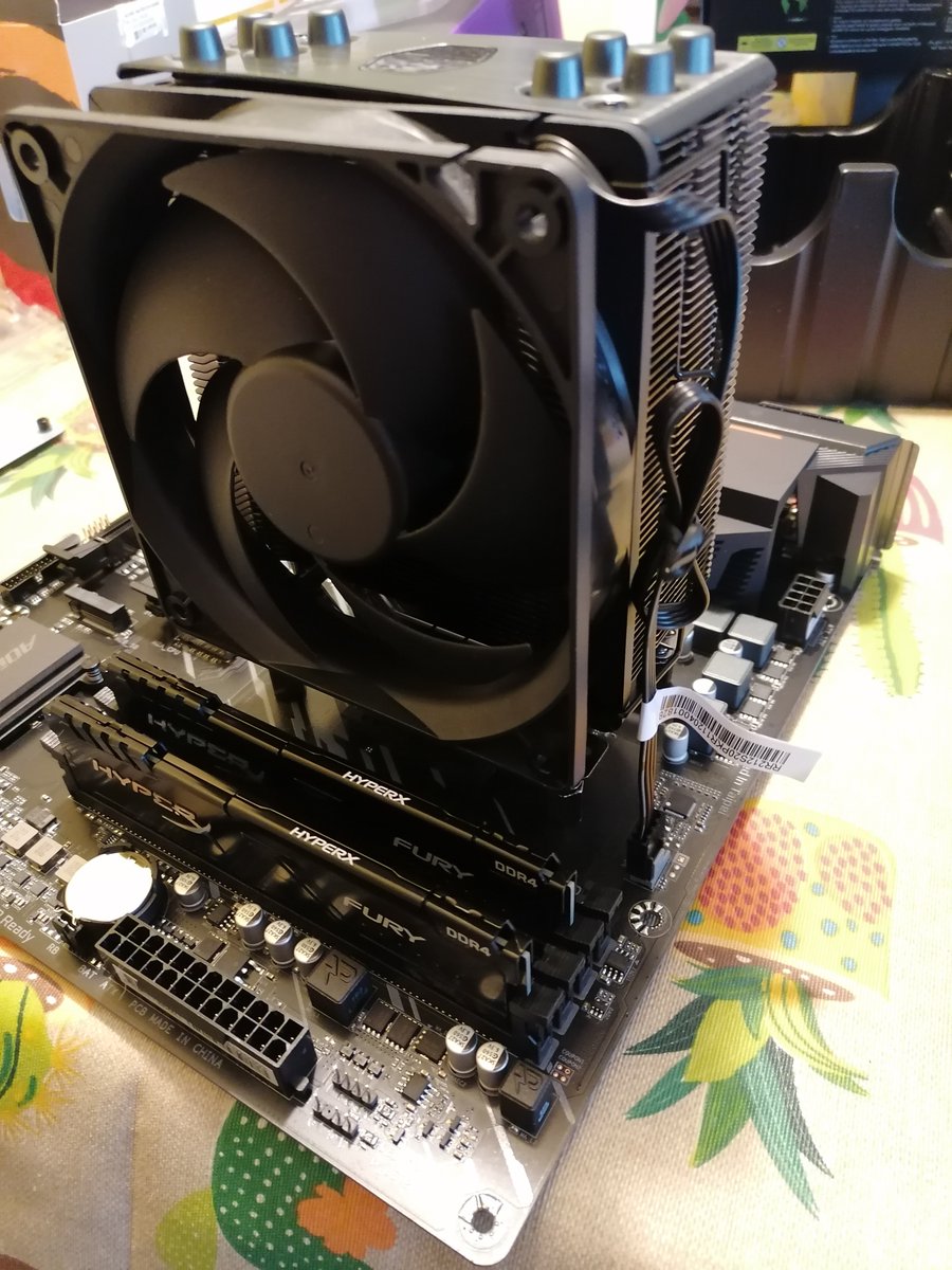 Step 7: Assemble CPU cooler, apply thermal paste to the CPU and screw everything tight. Don't forget to connect the fan connector to the motherboard.