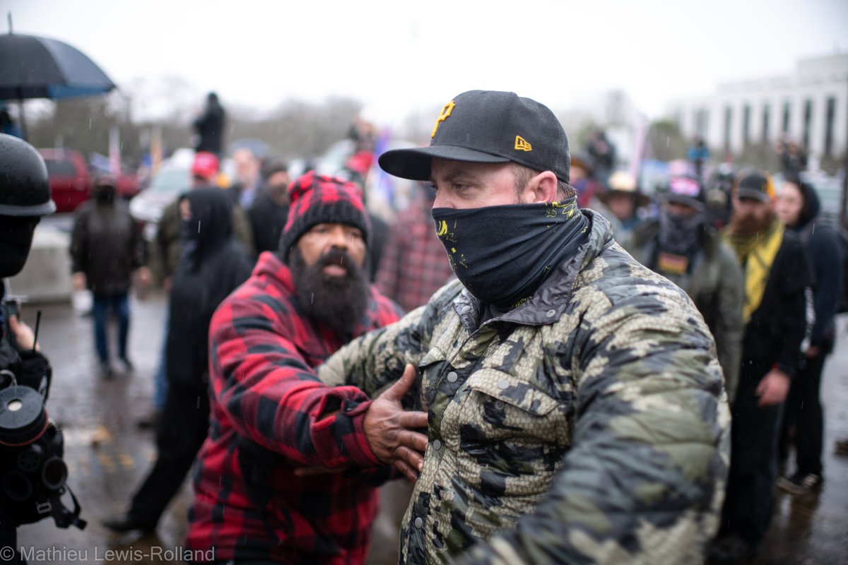 (8) Members of the Proud Boys advance on counter-protesters with threats and paintball guns as others within the group try to deescalate.