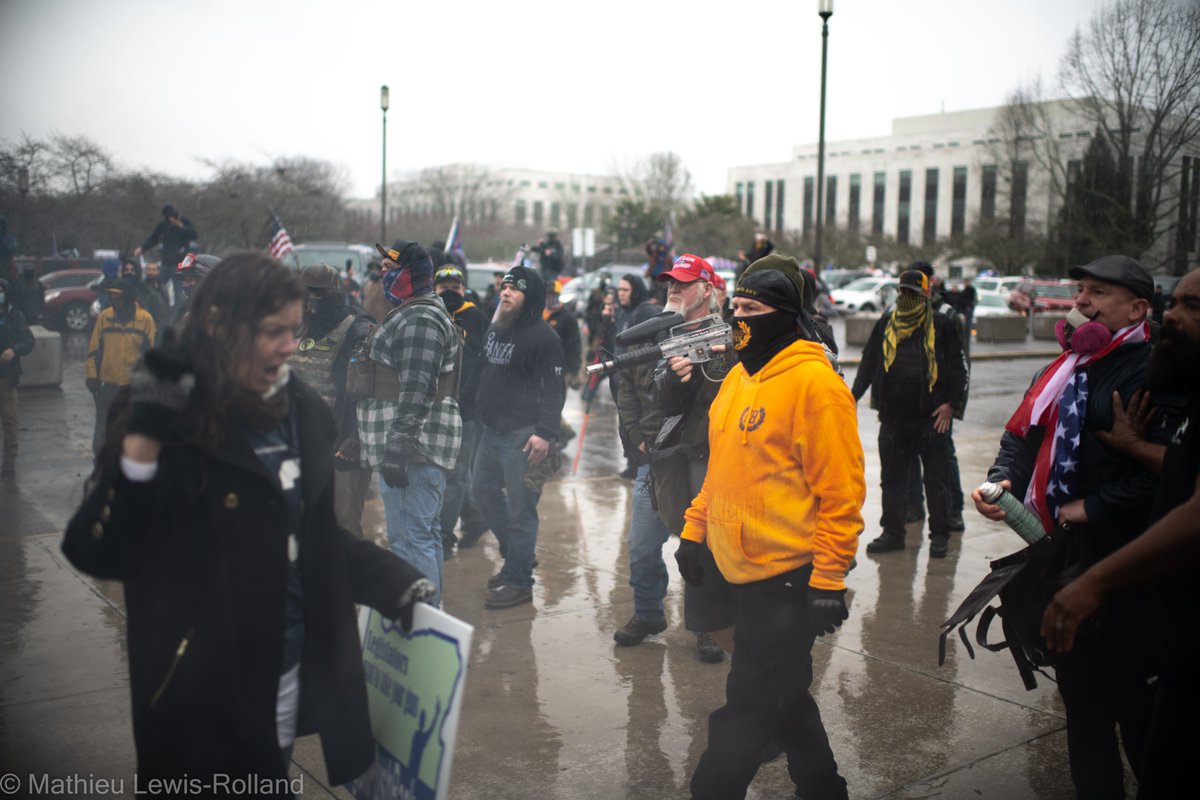 (8) Members of the Proud Boys advance on counter-protesters with threats and paintball guns as others within the group try to deescalate.