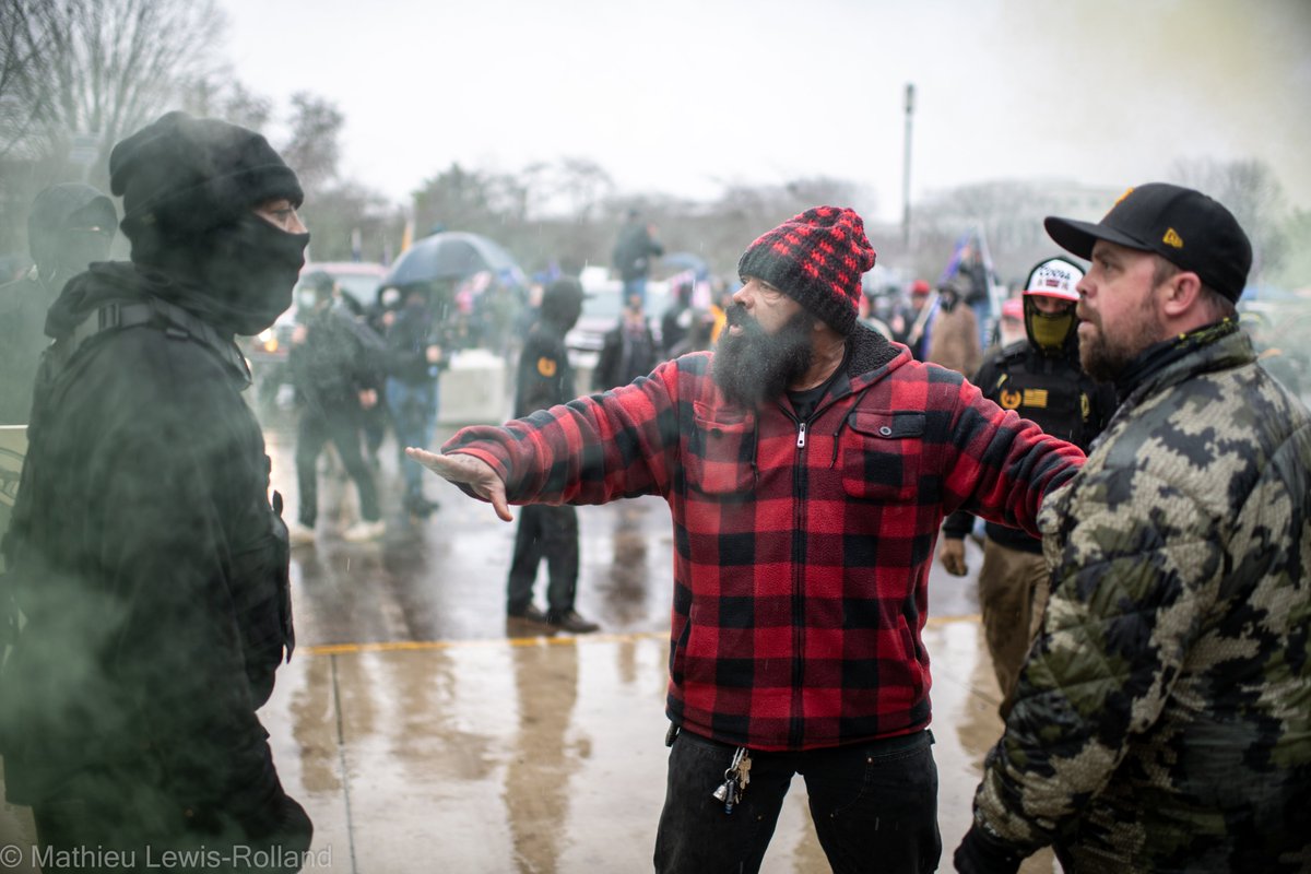 (8) Members of the Proud Boys advance on counter-protesters with threats and paintball guns as others within the group try to deescalate.