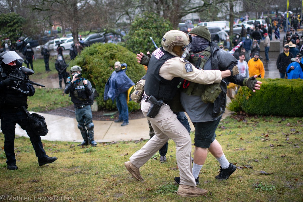 (11) David Willis is arrested after shooting projectiles into the crowd of counter-protesters.