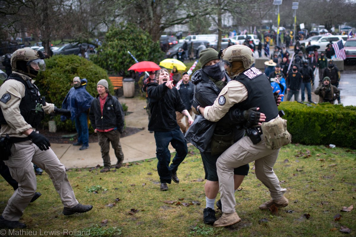 (11) David Willis is arrested after shooting projectiles into the crowd of counter-protesters.