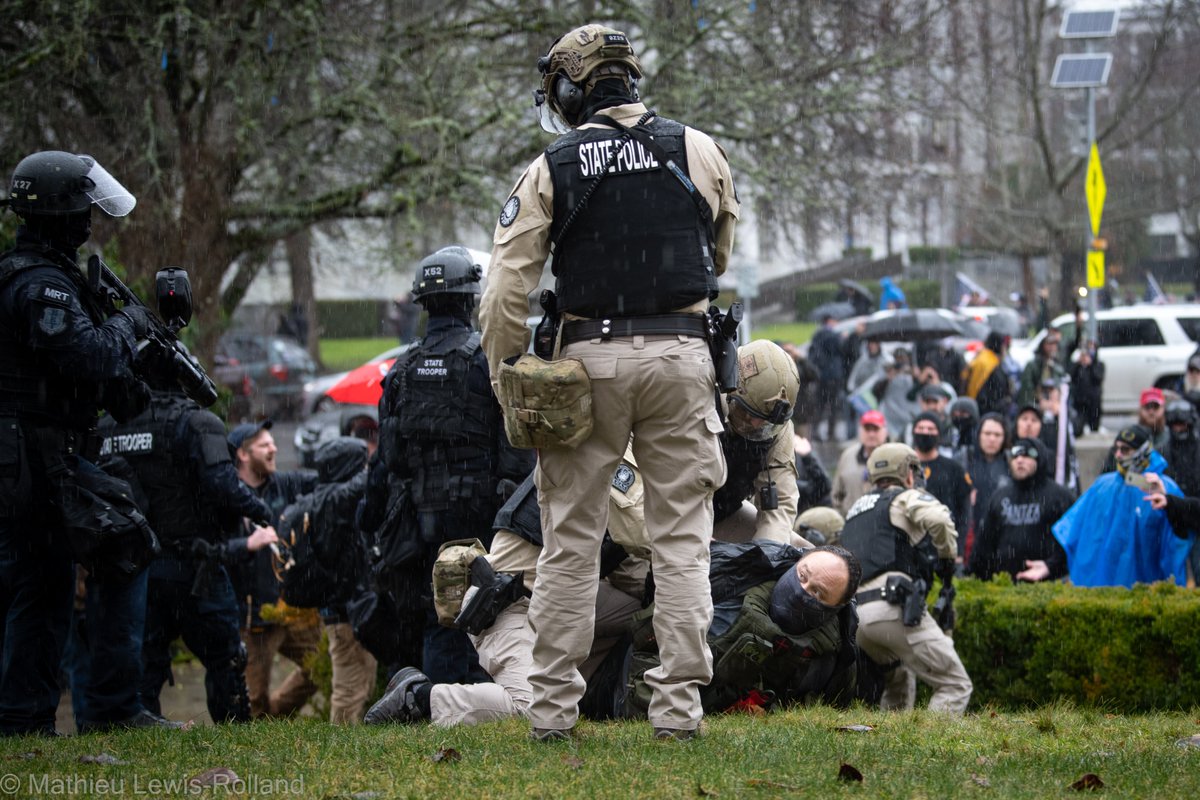 (11) David Willis is arrested after shooting projectiles into the crowd of counter-protesters.